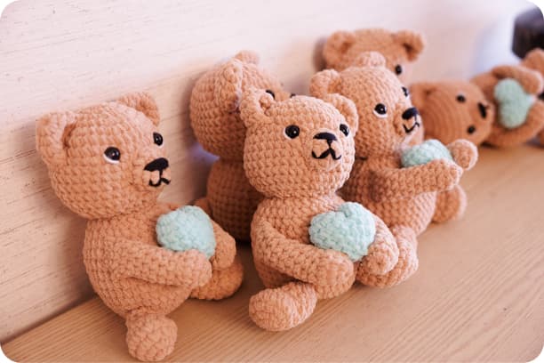 Hand-crocheted bears made by the GM1 community — one per family